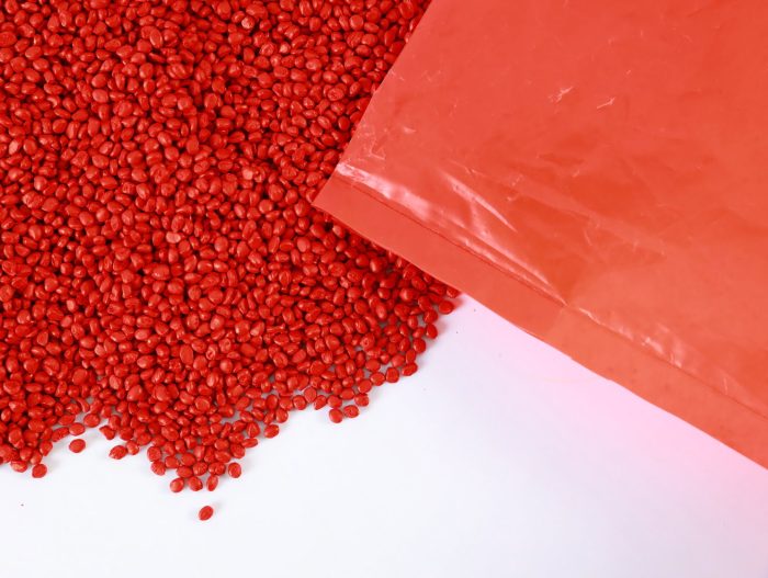 Vibrant red Mega Plast masterbatch pellets, delivering exceptional color consistency and performance